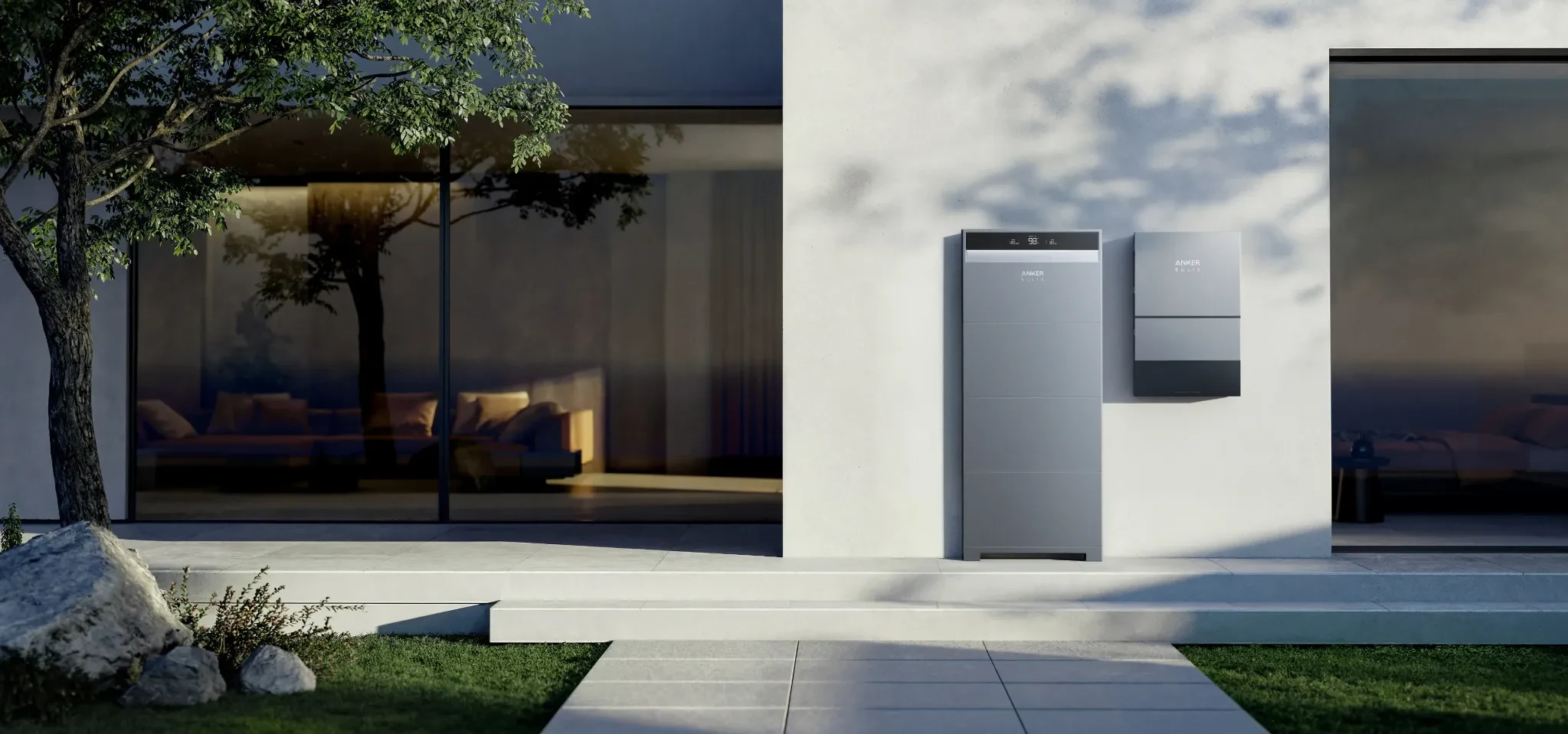 Anker SOLIX X1 home battery and Power Dock displayed outside a modern home